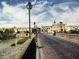 Córdoba: Lily stands on the Roman Bridge over the Guadalquivir River into Cordoba